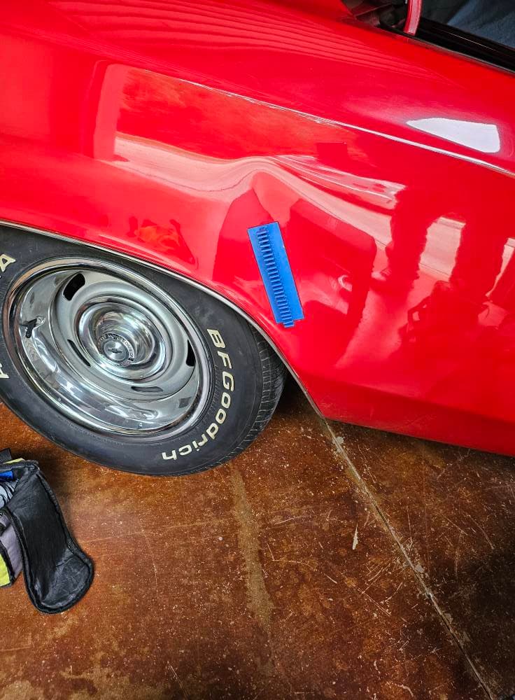 Red classic car panel before paintless dent repair