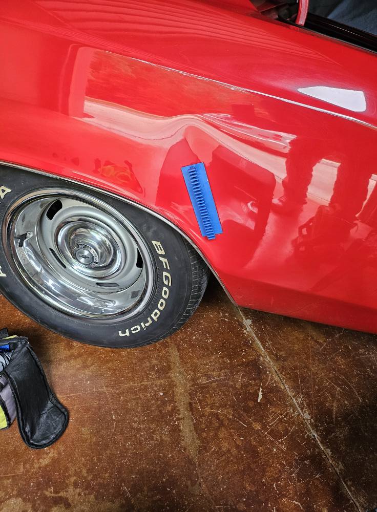 Before: fender dent on red classic car in Central North Carolina