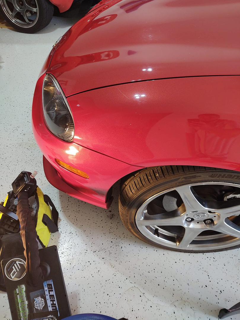 After: fender dent corrected with paintless dent repair on sports car