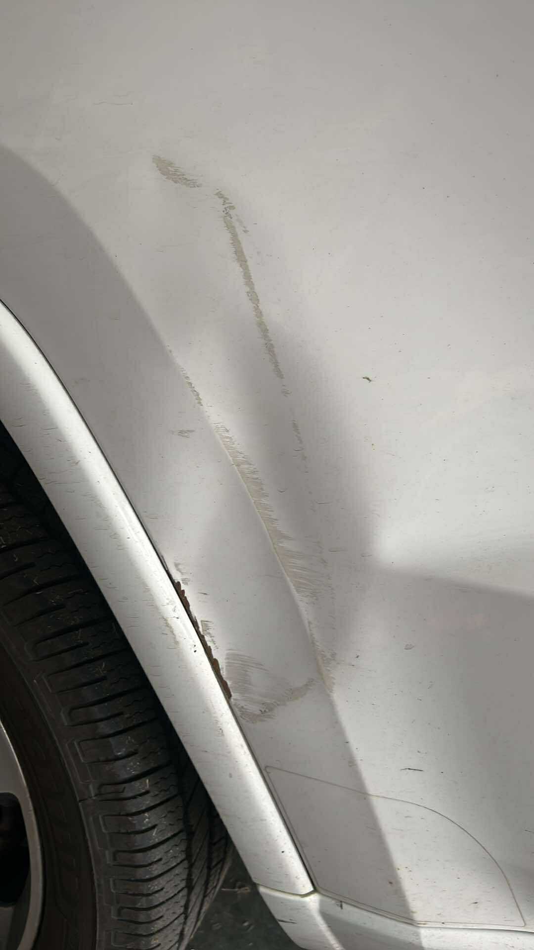 Before: fender dent on white SUV in Central North Carolina
